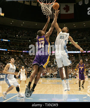 Denver Nuggets' Marcus Camby (23) dunks as Los Angeles Clippers' Chris ...