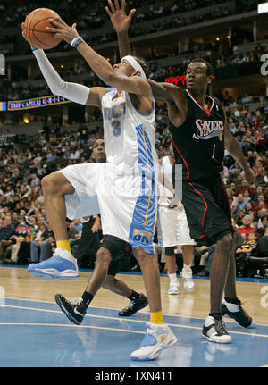 Denver Nuggets guard Allen Iverson (L) slips past Philadelphia 76ers center Samuel Dalembert during the first quarter at the Pepsi Center in Denver on January 6, 2008.   (UPI Photo/Gary C. Caskey) Stock Photo