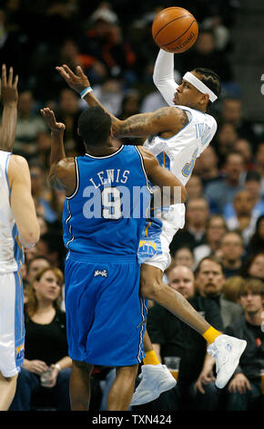 Denver Nuggets guard Allen Iverson (R) passes off driving the lane against Orlando Magic forward Rashard Lewis at the Pepsi Center in Denver on January 11, 2008.   (UPI Photo/Gary C. Caskey) Stock Photo