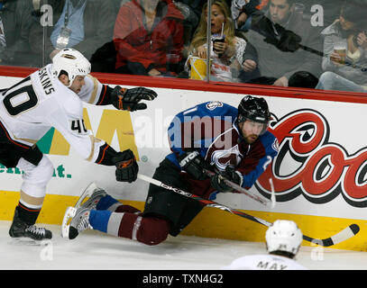 Anaheim Ducks defenseman Kent Huskins (L) takes down Colorado Avalanche center Peter Forsberg during the first period at the Pepsi Center in Denver on March 6, 2008.  The Ducks are the defending Stanley Cup champions.   (UPI Photo/Gary C. Caskey) Stock Photo