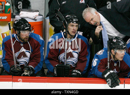 Colorado Avalanche head coach Joel Quenneville (top right) talks to left winger Wojtek Wolski (C) during the first period against the Anaheim Ducks at the Pepsi Center in Denver on March 6, 2008.   Avalanche center Peter Forsberg (L) of Sweden and Paull Stastny sit on either side of Wolski.  The Ducks are the defending Stanley Cup champions.   (UPI Photo/Gary C. Caskey) Stock Photo