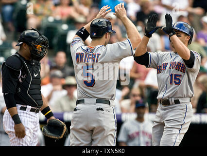 New York Mets center fielder Carlos Beltran (15) high fives teammate David Wright after hitting a two-run home run against the Colorado Rockies during the third inning at Coors Field in Denver on June 22, 2008.  Rockies catcher Yorvit Torrealba watches the celebration.  (UPI Photo/Gary C. Caskey) Stock Photo