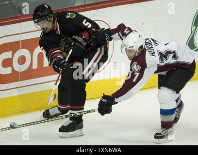 Chicago Blackhawks defenseman Brent Sopel (5) clears the puck against Colorado Avalanche center T.J. Hensick during the first period at the Pepsi Center in Denver on December 12, 2008.  (UPI Photo/Gary C. Caskey) Stock Photo