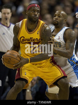 Cleveland Cavaliers forward LeBron James (23) looks to move against the shorter Denver Nuggets guard Anthony Carter during the first quarter at the Pepsi Center in Denver on December 19, 2008.  (UPI Photo/Gary C. Caskey) Stock Photo