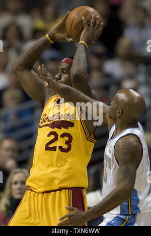 Cleveland Cavaliers forward LeBron James (L) looks to pass off against Denver Nuggets guard Anthony Carter during the first quarter at the Pepsi Center in Denver on December 19, 2008.  (UPI Photo/Gary C. Caskey) Stock Photo