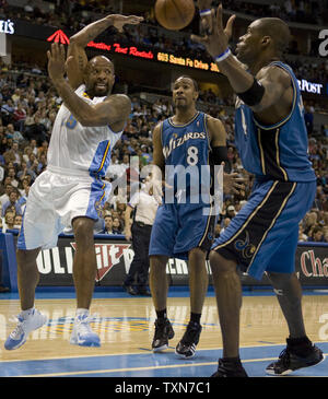 Denver Nuggets guard Anthony Carter (L) passes off against Washington .Wizards guard Javaris Crittendon and Antawn Jamison (R) during the second half at the Pepsi Center in Denver on March 20, 2009.  Denver beat Washington 116-105.  (UPI Photo/Gary C. Caskey) Stock Photo