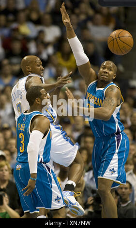 Denver Nuggets guard Chauncey Billups (L) passes off driving against New Orleans Hornets Chris Paul (3) and David West in the first quarter during game five of their first round series at the Pepsi Center in Denver on April 29, 2009.     (UPI Photo/Gary C. Caskey) Stock Photo