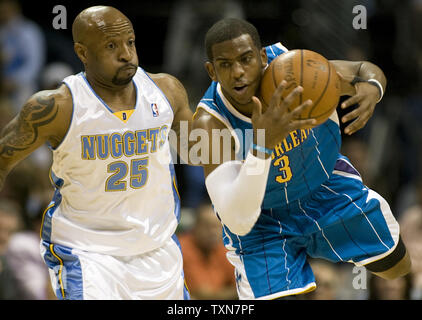 New Orleans Hornets guard Chris Paul bobbles the ball getting past Denver Nuggets guard Anthony Carter in the last seconds of the first quarter during game five of their first round series at the Pepsi Center in Denver on April 29, 2009.     (UPI Photo/Gary C. Caskey) Stock Photo