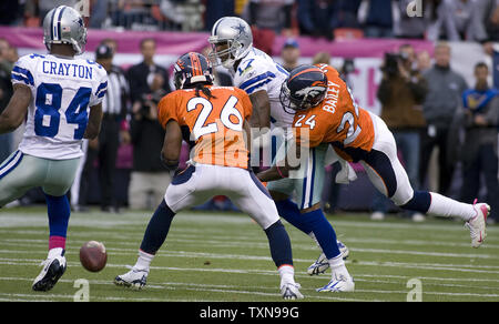 Denver Broncos cornerback Champ Bailey knocks down a fourth down and two at  the two pass to Dallas Cowboys wide receiver Sam Hurd at Invesco Field at  Mile High in Denver on