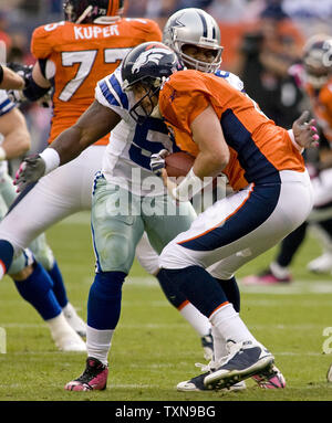 Dallas Cowboys linebacker Bradie James sacks Denver Broncos quarterback Kyle Orton in the second half at Invesco Field at Mile High in Denver on October 4, 2009.  Denver (4-0) remains unbeaten with a 17-10 victory over Dallas.      UPI/Gary C. Caskey... Stock Photo