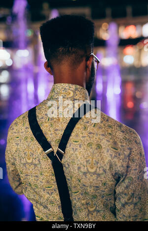 Rear view of man wearing suspenders over shirt Stock Photo