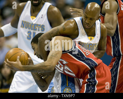 Denver Nuggets guard Chauncey Billups (R) fouls New Jersey Nets guard Chris Douglas-Roberts during the first quarter at the Pepsi Center in Denver on November 24, 2009.  New Jersey is the only winless team in the NBA.     UPI/Gary C. Caskey... Stock Photo