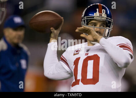 New York Giants quarterback Eli Manning (10) warms up as head coach Tom Coughlin watches at Invesco Field at Mile High in Denver on November 26, 2009.    UPI/Gary C. Caskey... Stock Photo