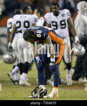 Denver Broncos tight end Tony Scheffler (C) celebrates his seven-yard  touchdown pass reception with teammate Rod Smith (R) and Brandon Marshall  (L) in the fourth quarter against the San Francisco 49ers at