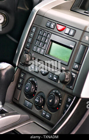 Luxury prestige car interior details. Middle console with gearbox air and multimedia controls. Stock Photo