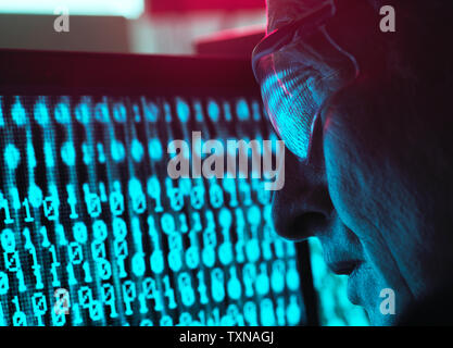 Cyber Security, Man looking at computer screen which is being infected by a virus Stock Photo