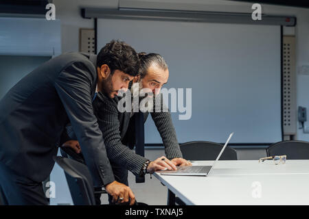 Business partners using laptop in office Stock Photo