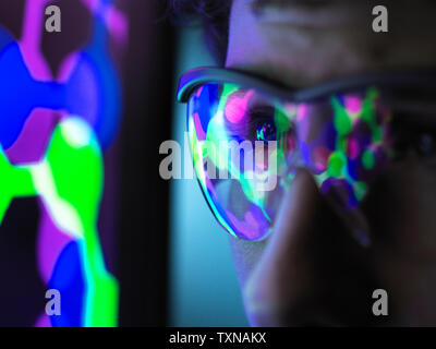 Student understanding the design of a molecular structure on computer screen in laboratory, close up Stock Photo