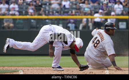 Colorado Rockies second baseman Jonathan Herrera (18) completes a double play over San Francisco Giants third baseman Pablo Sandoval in the sixth inning at Coors Field on July 4, 2010 in Denver.                 UPI/Gary C. Caskey Stock Photo
