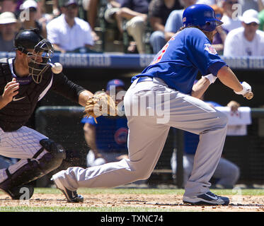 Chicago Cubs relief pitcher James Russell fouls a bunt attempt off the mask of Colorado Rockies catcher Chris Iannetta during the second inning at Coors Field on August 1, 2010 in Denver.         UPI Photo/Gary C. Caskey Stock Photo