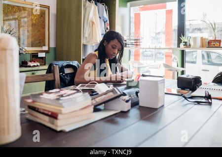 Young businesswoman remote working at cafe table Stock Photo