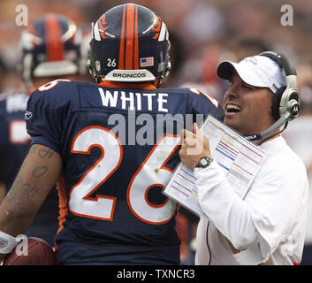 Denver Broncos head coach Josh McDaniels (R) congratulates running back  LenDale White (26) after his two-yard touchdown run against the Pittsburgh  Steelers during the first quarter at Invesco Field at Mile High