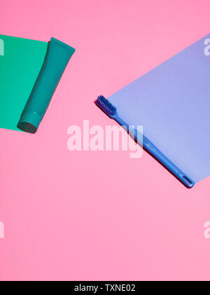 Toothbrush and toothpaste on pink background Stock Photo