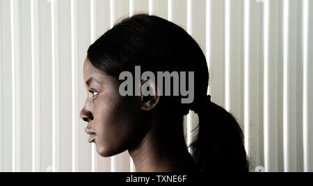 Young woman with ponytail, head profile portrait Stock Photo