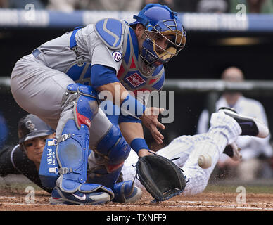 Colorado Rockies outfielder Carlos Gonzalez (behind) scores against Chicago Cubs catcher Geovany Soto during the first inning at Coors Field on in Denver on April 17, 2011.  The Rockies stand atop the major league won/loss standings with a 11-3 record.    UPI/Gary C. Caskey Stock Photo