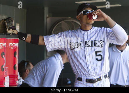 Colorado Rockies' Carlos Gonzalez takes a practice swing as he