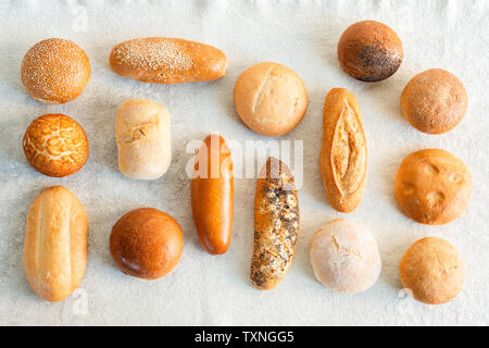 Large variety of wholemeal and white bread rolls, overhead view Stock Photo