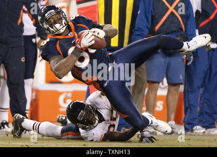 Chicago Bears wide receiver Johnny Knox (R) is tackled by Atlanta Falcons  defensive back Thomas DeCoud (28) and defensive back Dunta Robinson (23)  after a 25-yard reception during the first quarter at