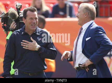 Houston Texans head coach Gary Kubiak and Denver Broncos Executive Vice-President of Football Operations John Elway talk before their game at Sports Authority Field at Mile High on September 23, 2012 in Denver.  Kubiak played backup quarterback to Elway on the Broncos team.     UPI/Gary C. Caskey Stock Photo