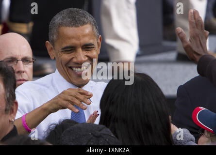 President Barack Obama shakes hands after speaking at a campaign rally at City Park in Denver on October 24, 2012. Stock Photo