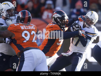 Denver Broncos defensive end Jeremy Mincey (57) wipes his face as