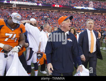 Denver Broncos head coach John Fox (C) and President of Football Operations John Elway (R) head to the victory podium after the AFC Championship game at Sports Authority Field at Mile High in Denver on January 19, 2014.   Denver will be the home team against the Seattle Seahawks in Super Bowl XLVIII at MetLife Stadium in East Rutherford, New Jersey February 2nd.   (FILE PHOTO)  UPI/Gary C. Caskey Stock Photo