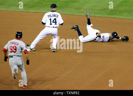 St. Louis Cardinals' So Taguchi is congratulated by third base