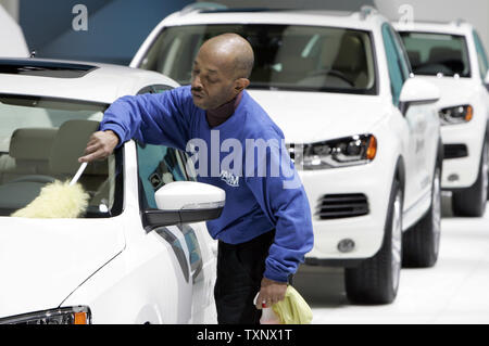 A worker cleans the new line of Volkswagen revealed at the 2011 North American International Auto Show at the Cobo Center in Detroit, January 11, 2011. UPI Photo/Mark Cowan Stock Photo