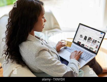 Ethnic woman shopping online using laptop Stock Photo