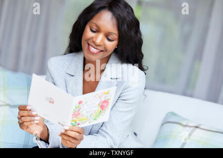 Woman reading a card Stock Photo
