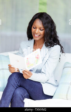 Woman reading a card Stock Photo