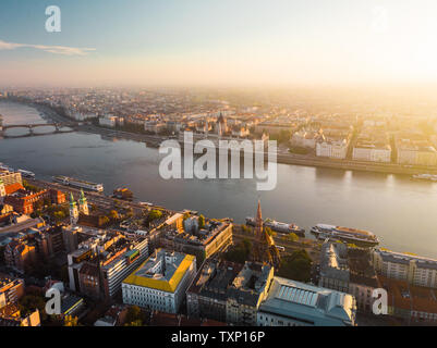 Aerial view onto Hungarian Parliament Building from above in front of Danube river during sunrise in Budapest in autumn with sunshine (Budapest) Stock Photo