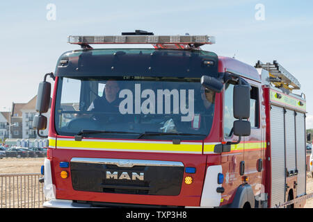 Close-up front view of British fire engine on duty, on the beach, at Weston-super-Mare, UK. Stock Photo