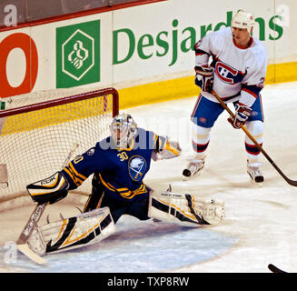 Buffalo Sabres goalie Ryan Miller (30) does the splits to make a save as Montreal Canadiens right wing forward Alexei Kovalev (27) of Russia watches in the first period at the Bell Centre in Montreal, Canada on December 9, 2006. (UPI Photo/Ed Wolfstein) Stock Photo