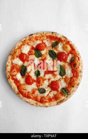 Margherita Pizza is a typical pizza from Naples, made with tomatoes, cheese,fresh basil, salt and olive oil. Stock Photo