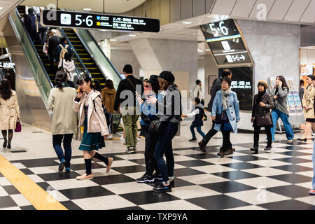 Kyoto, Japan - April 13, 2019: Inside interior of Kyoto Station underground with people busy walking by escalator platforms Stock Photo