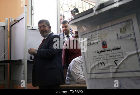 Presidential candidate Mohamed Morsy of the Muslim Brotherhood arrives to cast his vote at a polling station in a school in Al-Sharqya, 60 km (37 miles) northeast of Cairo in Egypt, June 16, 2012. Egypt's first free presidential election concludes this weekend in a run-off between the Muslim Brotherhood's candidate Mohamed Morsy and Ahmed Shafik, the last prime minister of ousted leader Hosni Mubarak. UPI/Ahmed Jomaa Stock Photo