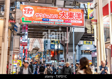 Osaka, Japan - April 13, 2019: Entrance to famous covered arcade street with people crowd walking shopping with sign Stock Photo