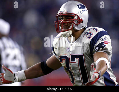 New England Patriots safety Rodney Harrison is dressed for the cold as he  stands on the stadium field as practice begins at the NFL football team's  facility in Foxborough, Mass., Thursday afternoon