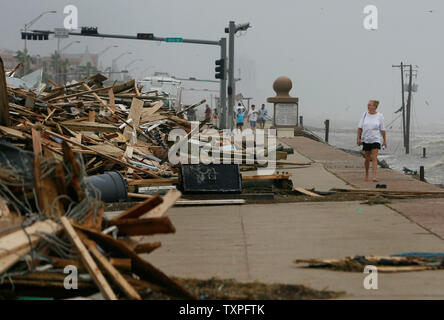 Michelle Ricketson surveys the debris that came ashore from Hurricane Ike in Galveston, Texas on September 13, 2008. Hurricane Ike hit the Texas coast early today. (UPI Photo/Aaron M. Sprecher) Stock Photo